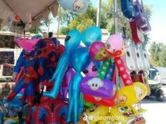 many balloons are on display at an outdoor market