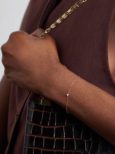 Persée's signature "pierced" technique is achieved by carefully puncturing a gem with a laser, which creates the illusion it's floating outside of a setting. This 'Danaé' bracelet is strung with a sparkling diamond on a dainty gold chain. Layer yours with other styles from the brand. Minimalist Single Diamond Jewelry For Everyday Luxury, Luxury Sterling Silver Bracelets With Single Cut Diamonds, Luxury Sterling Silver Bracelet With Single Cut Diamonds, Silver 14k Gold Hand-set Diamond Bracelet, Timeless Hand-set Platinum Jewelry, Luxury Round Sterling Silver Bracelet With Single Cut Diamonds, Sterling Silver Single Diamond Jewelry For Everyday Luxury, Elegant Formal Bracelets With Single Cut Diamonds, Elegant Bracelets With Single Cut Diamonds