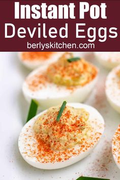 deviled eggs with sprinkles and seasoning in them on a white surface