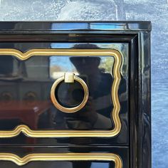 an ornate black and gold dresser with handles