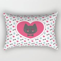 a heart shaped pillow with a cat's face on it