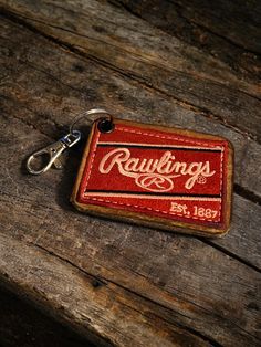 This is a leather Keychain repurposed from a Rawlings baseball glove. Features chrome hardware, premium leather backing and Rawlings embroidered patch with natural burnished edges. Great for your keys or show your brand loyalty and hang on your bag. I've also seen these used as Christmas ornaments. Truly one of a kind! Patch Keychain, Baseball Leather Crafts, Vintage Leather Patch Backpack, Vintage Keychains, Vintage Wallet With Interior Key Chain Holder, Vintage Baseball Gloves, Rawlings Baseball, Brand Loyalty, Chrome Hardware