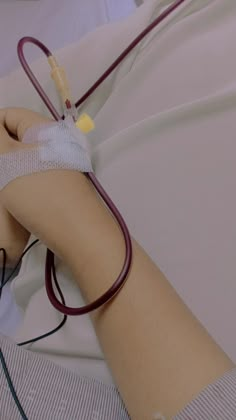 a person in a hospital bed with an iv hooked up to their arm