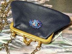 One of a Kind vintage navy blue leather coin purse. This coin purse is really in perfect condition, which is rare. I added a piece of vintage jewelry to add a bit of charm. It would make the perfect gift. I T E M ∙ S P E C I F I C A T I O N S - PURSE SIZE: 5" x 3" frame opens about 2 1/2" and you could put something little inside - CHAIN LENGTH: 52" total length brass link chain, you can double the chain and make the necklace short C A R E ∙ T I P S: We don’t want your special moment to fade. To Vintage Clutch Coin Purse As Gift, Handmade Blue Coin Purse For Gift, Blue Clutch Coin Purse For Gift, Gift Blue Clutch Coin Purse, Leather Coin Purse, Bracelet Collection, Jewelry Cleaner, Gift Collections, Blue Leather