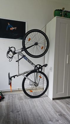 a bicycle is suspended upside down in the air with wheels attached to it's frame