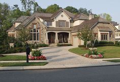 a large house with lots of windows and landscaping