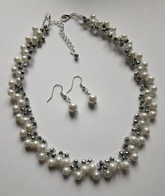 Crystal & Pearl Glass Beaded Necklace Stunning handcrafted design A vintage style beaded necklace In a Silver & white sparkling theme Perfect for weddings,parties & glamorous nights out     Intricate hand woven design     3mm Silver Plated faceted glass crystal rondelle beads     11/0 silver lined glass seed beads     6mm White glass pearl beads     Lobster clasp fastening     Extension Chain     16" plus extension     Complete with organza gift pouch FREE PAIR 8MM GLASS PEARL EARRINGS TO MATCH Hand Beaded Bag, Prom Accessories, Set Earrings, Silver Line, Pearl Crystal, Woven Design, Gift Pouch, Glass Bead Necklace, Glass Seed Beads