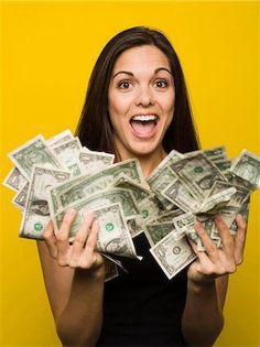 a woman holding money in front of her face and making a funny face with it's hands