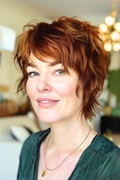 Tousled Shaggy Pixie Hairstyle on smiling woman with in her 50s with dark copper hair. Short Choppy Shag Haircut, Short Edgy Shag Haircut, Wavy Shag Haircut Short, Folding Sweaters, Pixie Shag Haircut, Short Wolf Haircut, Short Layered Haircuts For Women, Pixie Shag, Wavy Layered Haircuts