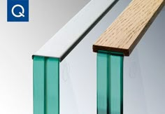 a close up of a wooden and glass railing