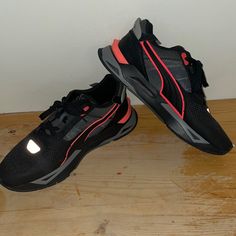 Brand New Puma Sneakers Never Worn Black/Orange-Red Stripe Holographic Black Puma Running Shoes For Sports, Black Puma Running Shoes, Black Puma Athleisure Running Shoes, Black Athleisure Running Shoes With Puma Logo, Black Puma Sneakers For Sports, Functional Black Running Shoes With Puma Logo, Sporty Black Puma Sneakers, Orange Lace-up Puma Sneakers, Black Puma Running Sneakers