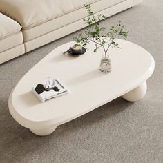 a white coffee table sitting on top of a carpeted floor next to a couch