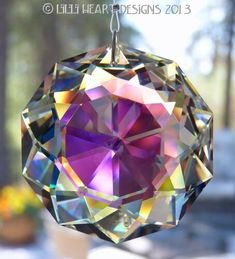 an ornament hanging from a string with colorful crystals