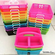 several plastic containers stacked on top of each other with handles and dividers in different colors