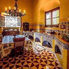 an ornate dining room with tiled flooring and chandelier hanging from the ceiling