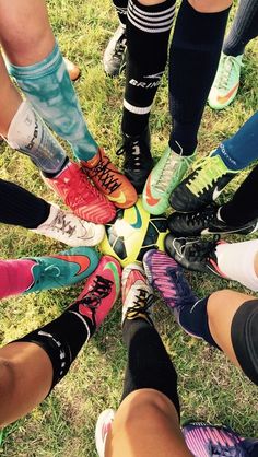 a group of people standing in a circle with their feet on each other's ankles