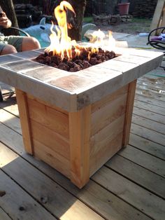 a fire pit sitting on top of a wooden deck