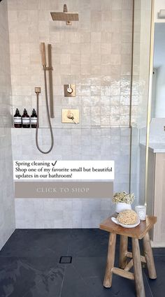 a bathroom with a stand up shower and wooden stool