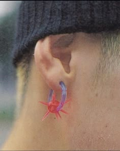 a close up of a person's ear with a spider on it