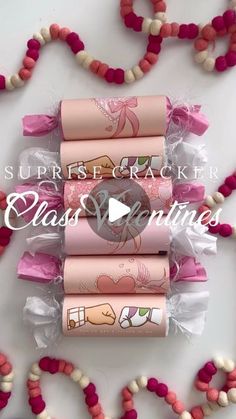 four pink and white candy rolls in celloine wrappers on top of each other