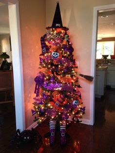 a decorated halloween tree with purple and orange decorations