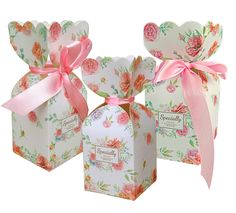 three small boxes with pink bows and flowers on the front, one has a bow at the top