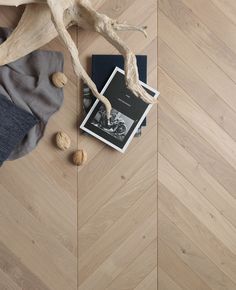 a book and some nuts on a wooden floor