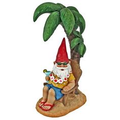 a statue of a gnome sitting under a palm tree