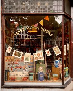 a store front window filled with books and pictures