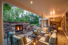 an outdoor living area with fireplace and seating