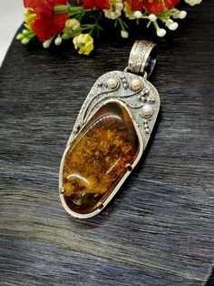 Artisan Amber with pearls pendant  Hand-made Sterling Silver 925.  Stones used: Baltic Cognac Amber, Pearls.  Height -3 2/16” (with bail), Width – 1 3/16”  Height – 80mm, width-30mm.Unique Handcrafted One-of a-kind Design PendantEach Piece of Jewelry in my Collection is Absolutely One of a Kind!When you start wearing a piece of my jewelry you will fall in love with it more and more each day and feel that good Energy and Love that I pass into it while creating this piece of Art.A piece of Art cre Handmade Amber Sterling Silver Jewelry, Artisan Amber Sterling Silver Jewelry, Elegant Amber Jewelry With Large Pendant, Unique Pearl Pendant Jewelry, Handmade Amber Oval Pendant Jewelry, Artisan Sterling Silver Pearl Pendant Jewelry, Artisan Sterling Silver Jewelry With Pearl Pendant, Unique Amber Sterling Silver Jewelry, Antique Amber Sterling Silver Jewelry