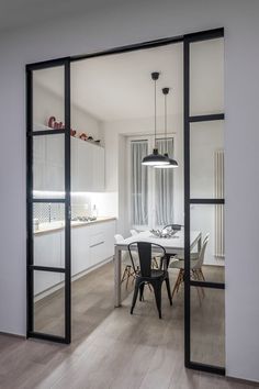 an open kitchen and dining room with sliding glass doors