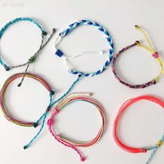 five bracelets with different colors and sizes on white background, one is multicolored