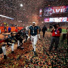 a football player walking through confetti on the field