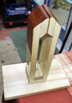 a wooden clock is sitting on top of a piece of plywood and some wood