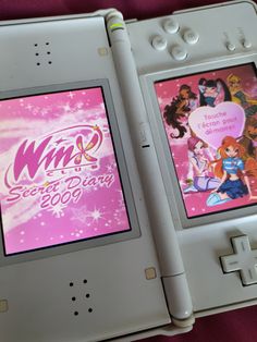 two nintendo wii games sitting next to each other on a pink surface with white buttons