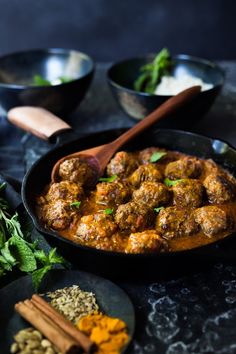 meatballs and spices in a skillet on a table