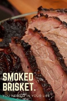 sliced meat sitting on top of a glass plate with the words smoked brisket you need it in your life