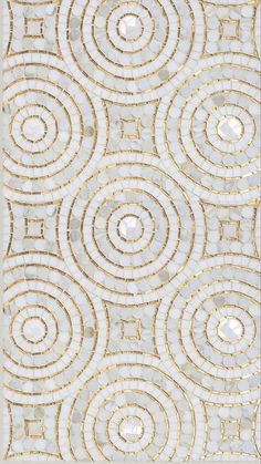 a white and gold rug with circles on it