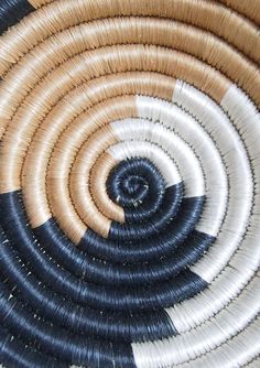 a close up view of some sort of woven basket with black, white and tan colors