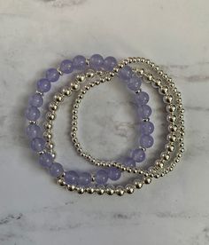 "Gorgeous bracelet stack made of three beaded bracelets: 1. 6mm purple amethyst quartzite beads with silver spacers 2. 5mm sterling silver beads 3. 3mm sterling silver beads These are perfect to wear alone, all together or add to a bracelet stack. The bracelets shown are approximately 7\" in length." Silver Beaded Bracelets With Gemstone Beads, Silver Beaded Bracelet With Gemstone Beads, Silver Amethyst Beaded Bracelets With Faceted Beads, Silver Gemstone Beaded Bracelets, Silver Amethyst Beaded Bracelets, Silver Beaded Bracelets For Healing, Silver Amethyst Beaded Bracelet With Faceted Beads, Healing Silver Beaded Bracelets With Faceted Beads, Purple Sterling Silver Beaded Bracelets With Round Beads