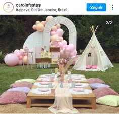 a table set up for a party with pink and white balloons on the back ground