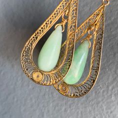 Delicate ~ Vintage Art Deco ~ Chinese carved Jade jadeite ~ solid 14kt yellow gold filigree and natural pearl dangle drop screw-back earrings ~ Marked 14kt for gold (also acid tested ). Dates first half of 20th century . Measurements : Earrings are 2 inches in drop length x 5/8 inches max width Weighs 8 grams on my weighing scale. Condition : Overall in good vintage condition ~ I did not see any chip to the stone ~ Some surface wear to the metal and pearls . Please Note ~ As vintage items are pr Ornate Green Earrings With Intricate Design, Ornate Green Filigree Earrings, Green Ornate Filigree Earrings, Green Filigree Dangle Jewelry, Green Filigree Drop Earrings, Green Filigree Earrings For Formal Occasions, Green Filigree Teardrop Earrings, Green Teardrop Filigree Earrings, Handmade Elegant Chrysoprase Earrings