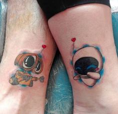 two people with matching tattoos on their legs, one has an alien and the other has a heart