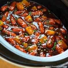 a crock pot filled with beans and sauce