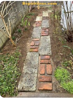 a brick path in the middle of a garden