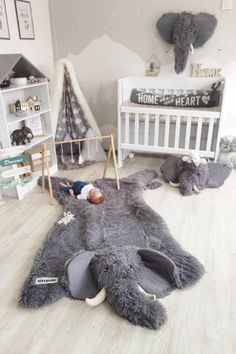 an elephant rug is on the floor in a child's room with other toys