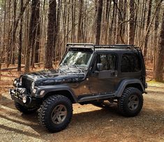 a jeep parked in the middle of a forest