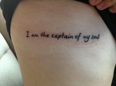 a woman's thigh with the words i am the captain of my soul tattooed on it