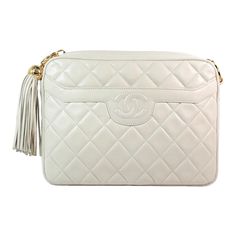 Chanel crossbody bag Made in Italy Soft cream quilted leather Stitched classic CC logo Front pocket Gold chain strap Strap length: 44 inches Hanging gold ball and leather fringe detail Cream leather lining Interior zippered pocket Comes with dustbag Serial number with authenticity card: 2104059 Chanel Watch J12, Paper Bag Princess, Chanel Cream, Chanel Crossbody, Chanel Watch, Chanel White, Leather Crossbody Bag Small, Leather Fringe, Cc Logo